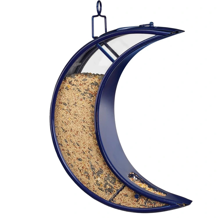 Crescent-shaped Over the Moon Fly-Thru Bird Feeder with mixed seeds, featuring a metal loop for hanging and heavy-duty plexiglass panels for visibility.