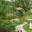 Adjustable Double Hanger in a garden, showcasing two arm hangers on a wrought iron pole designed to attract birds with stability and adjustable height.