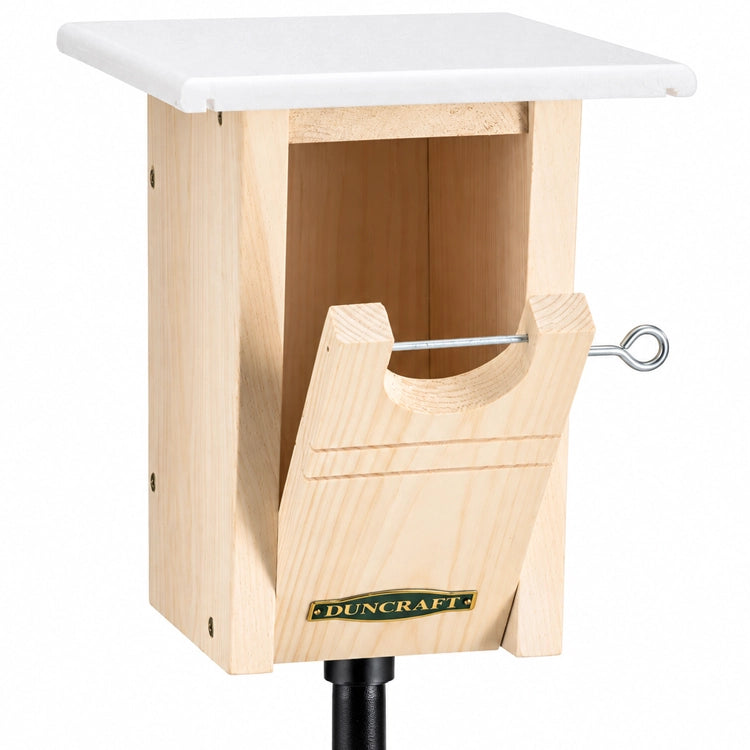 Duncraft Bluebird Trail House & Pole features a wooden box with a white top, oval entry hole, and a durable white recycled plastic roof for bird protection.