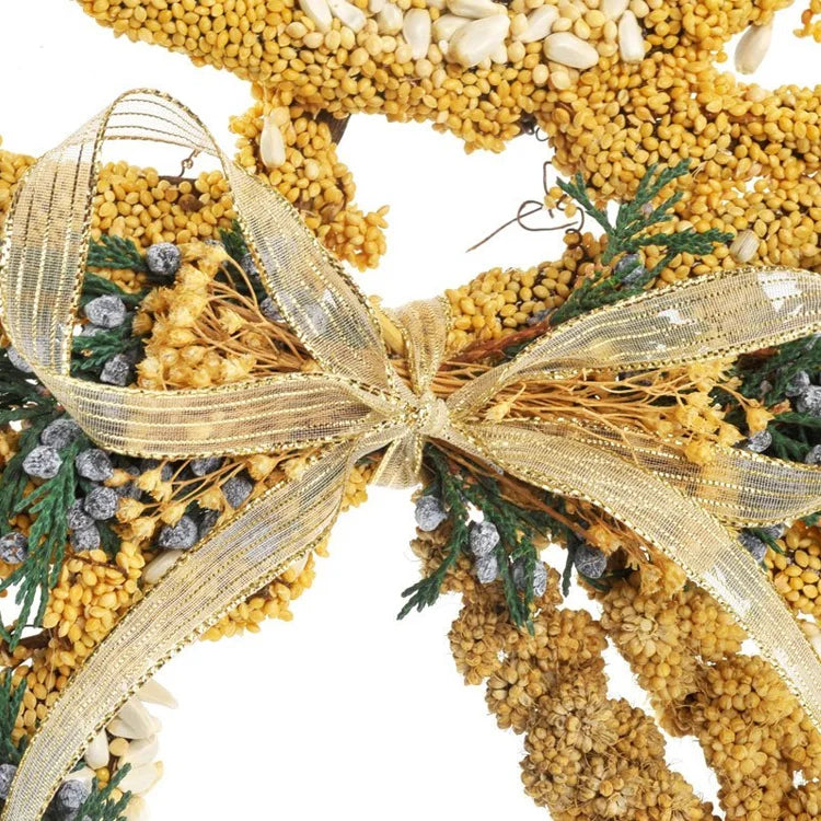 Wild Bird Seed Angel wreath with golden seeds, dried flowers, evergreen sprigs, and a gold ribbon bow, designed to attract birds and enhance outdoor décor.