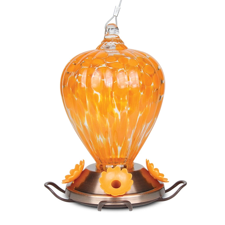 Art Glass Oriole Feeder with orange-infused glass and copper base, designed for nectar feeding and attracting attention with its artistic appearance.