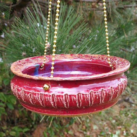 Bluebird Cafe Bird Feeder with a red bowl and gold chain, ideal for attracting birds. Elegant design for easy filling and cleaning.