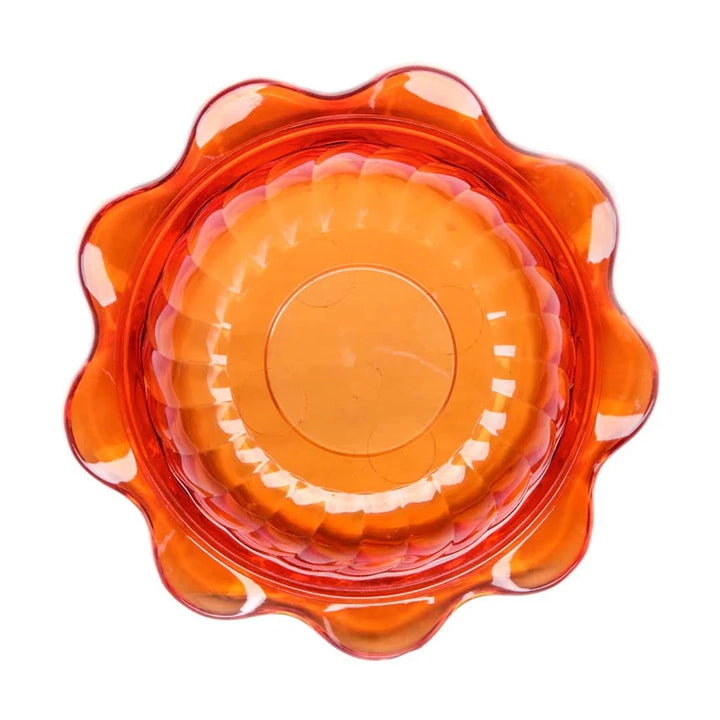 Stack of orange glass bowls on a white background