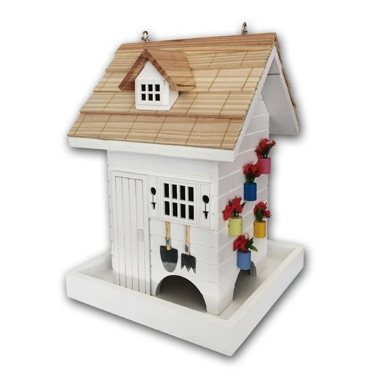 Potting Shed Bird Feeder, featuring a white birdhouse with decorative flowers and a functional design for easy seed dispensing and garden charm.