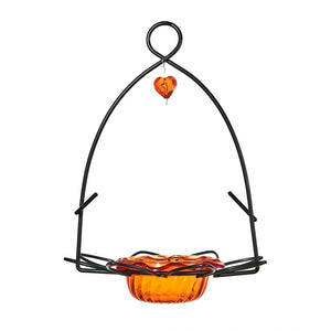 Hanging bird feeder with orange bowl and heart-shaped perch on a white background