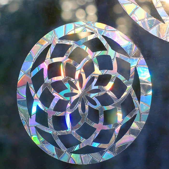 Mandala Window Gems, Set of 3, prismatic decals on a window, showcasing circular designs to prevent bird strikes and add elegance.