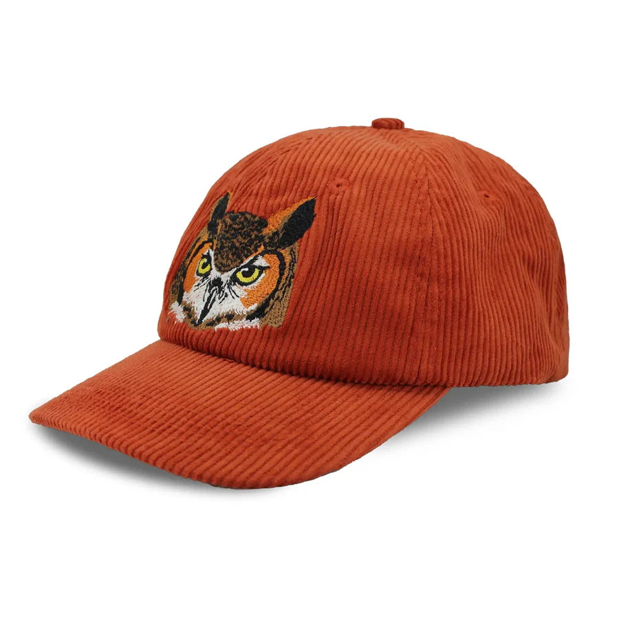 Chickadee Corduroy Hat, Burgundy features a rusty orange corduroy baseball cap with an embroidered Great Horned Owl design, adjustable strap, and six-panel crown.