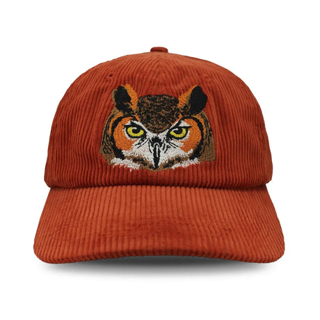Chickadee Corduroy Hat, Burgundy: Burnt-orange cap with embroidered Great Horned Owl face, featuring bright eyes and beak, on unstructured 6-panel corduroy with adjustable strap.