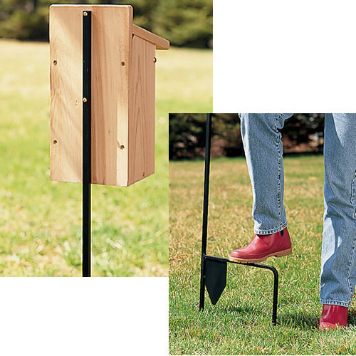 Person standing on a small wooden box, demonstrating the stability of the Birdhouse Mounting Pole with a foot stake for easy installation and support.