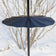 Superwide Pole Baffle mounted on a vertical pole, preventing squirrels from accessing bird feeders. Features a wraparound design and a steel mounting collar for secure placement.
