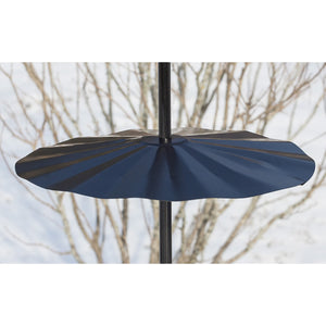 Superwide Pole Baffle in snowy setting, showcasing its large diameter and wraparound design to deter squirrels from bird feeders. Durable black powder-coated galvanized steel.