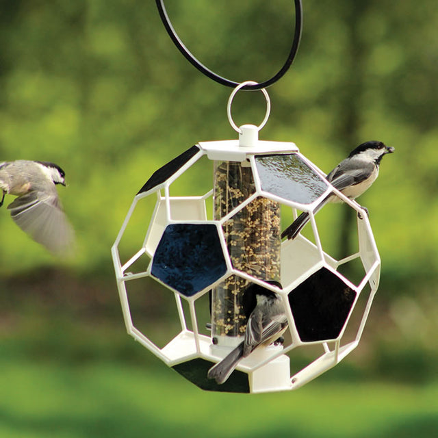 Soccer Ball Seed Feeder with perched birds, featuring a tube design, fly-through openings, two feeding ports, and a weather-resistant finish.