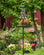 Brome Mega 600 Podium Kit with birds feeding, featuring a single pole, Seed Buster Tray, and six-port Mega600™ Feeder in a garden setting.