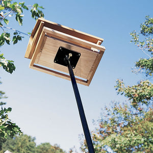 Heavy Duty Sectional Pole holding a bird feeder with a square wooden box, featuring a wide metal mounting bracket for stability.