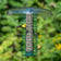 Bird feeder with birds perched on it against a green foliage background