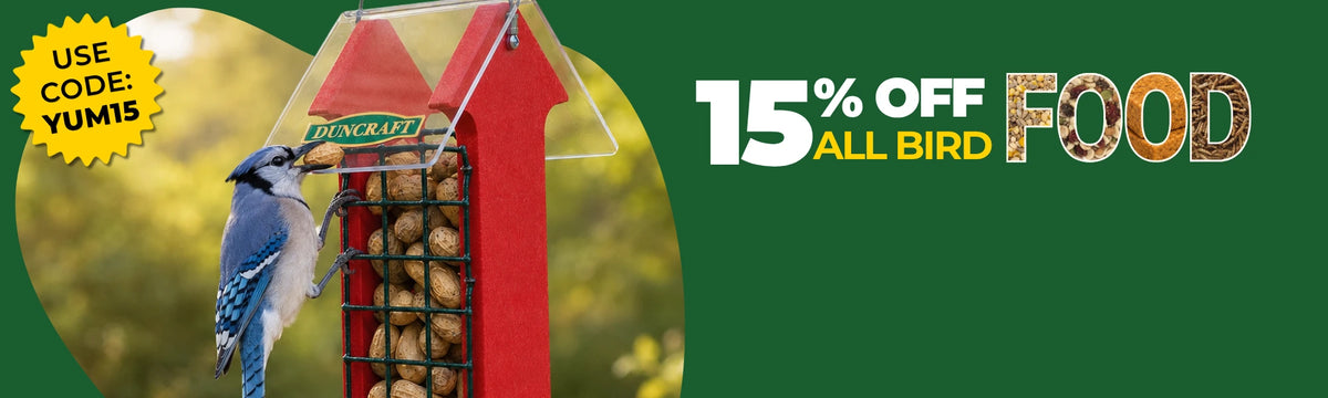 15% off all bird food. No code Needed. Bluebird at red feeder with Duncraft logo holding a peanut in it's beak. 