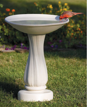 All-Seasons Heated Bath with 25 Pedestal showing a bird drinking from the water basin, placed on grass, with a 6-inch hidden cord for energy-efficient winter use.