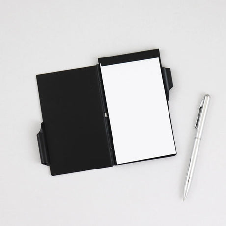 Flip Note with Botanical Leaves design, featuring a retractable pen and a spring-loaded, 50-sheet perforated notepad, all in a compact, durable aluminum case.