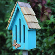 Butterfly Breeze House with copper butterfly on roof, crafted from cypress wood and copper. Comes with a 30-inch wooden stake for mounting.