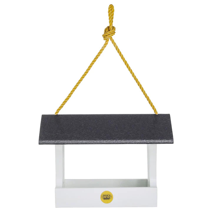 Modern Farmhouse Fly-Thru Bird Feeder with black top, hanging from yellow rope; features wide platform, mesh screen, and durable stainless steel fasteners.