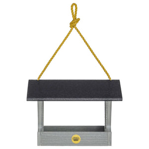 Modern Farmhouse Fly-Thru Bird Feeder, Driftwood, hanging from a yellow rope, features a black roof and durable mesh screen for drainage.