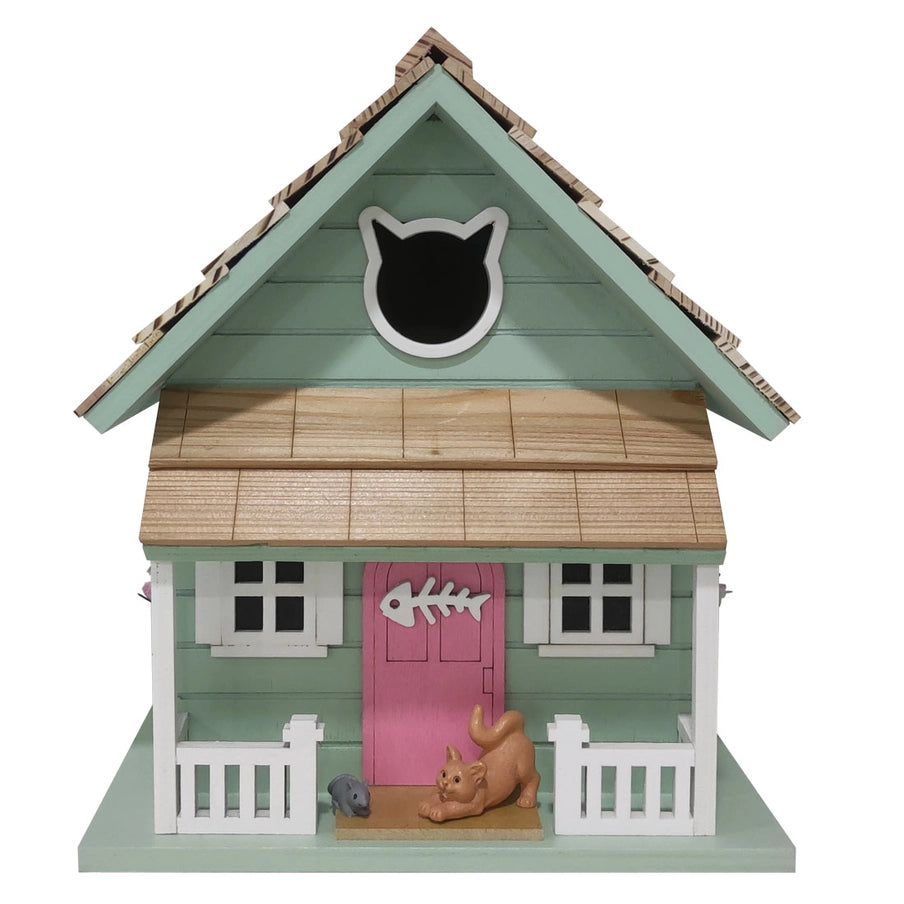 Kitty Cottage Birdhouse featuring a cat door, pink door with fish skeleton, white fence, and windows, designed for birds like wrens and finches.