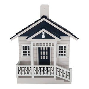 Welcome Home Cottage Birdhouse with pineapple details, carved railing, and black door, designed for small birds with proper ventilation and drainage.