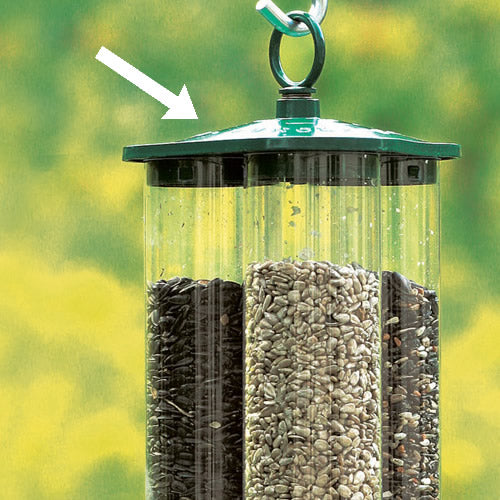 Duncraft's Green Triple Tube Top bird feeder with seeds, featuring a triangular top and locking loop with spring-loaded locking action.