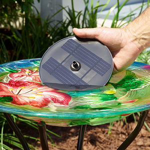 Hand holding AquaNura Solar Mini Birdbath Insert above a birdbath, showcasing its easy installation and suitability for creating a solar-powered fountain to attract birds.