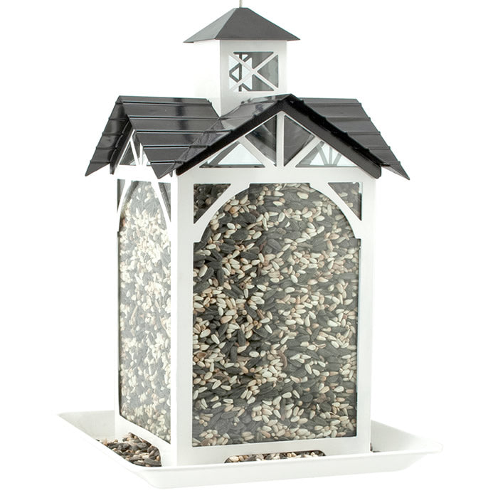 Modern Farmhouse Metal & Glass Stable Feeder with rice inside, featuring glass panels, a top-fill design, and a heavy metal cable for hanging.