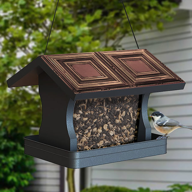 Modern Farmhouse Vintage Wood with Tin Roof Hopper Feeder showcasing a bird perched on it. Feeder design supports various birds and holds up to 4 lbs of seed.