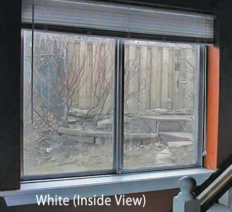 CollidEscape Window Protector, White, applied to a window, filters sunlight, and prevents bird strikes, offering daytime privacy while maintaining an outdoor view.