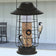Modern Farmhouse Solar Lantern Tube Feeder with birds perched, featuring a protective cage and solar light functionality for night, holds 1/2 lbs. of seed.