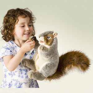 Young girl feeds a Gray Squirrel Hand Puppet, featuring a movable head, mouth, and arms, with a playful expression and soft, bushy tail.