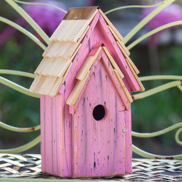 Bluebird Brights birdhouse on a bench, featuring a front panel for easy cleaning, 1-1/2 inch entry hole, and a copper-topped shingled roof.