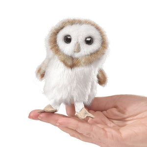 Hand holding a Folkmanis Mini Owl Finger Puppet, designed to resemble a natural bird of prey, perfect for interactive play and adventures.