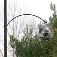 Quick Connect Coil Arm Hanger, 16 inches, shown attached to a pole with a bird feeder. Ideal for adding extra feeders to a 1-inch diameter pole.