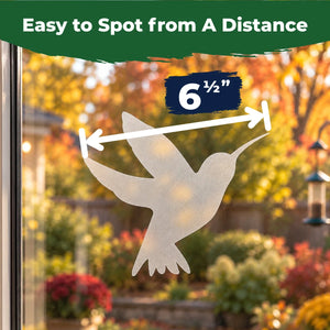 Translucent 6.5-inch hummingbird window decal applied to glass with a colorful backyard visible outside.