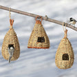 Roosting Pockets, Set of 3: Woven grass birdhouses hanging on branches, offering cozy shelter for small birds during cold or wet weather.