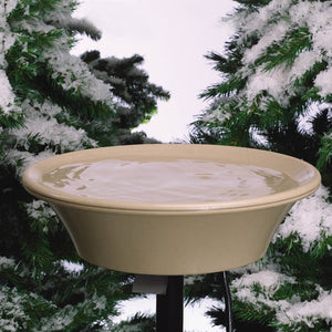 14 Heated Bird Bath with EZ-Tilt Deck and Pole Mount, shown in a snowy outdoor setting, providing ice-free water for birds year-round with thermostatic control.