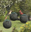 Green Seed Ball, Set of 3, hanging bird feeders with metal mesh and drainage holes, featuring a red bird feeding.