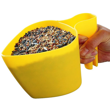 Scoop 'N Fill measuring cup with seeds, featuring a hand holding its handle, designed for easy bird feeder filling and seed storage.