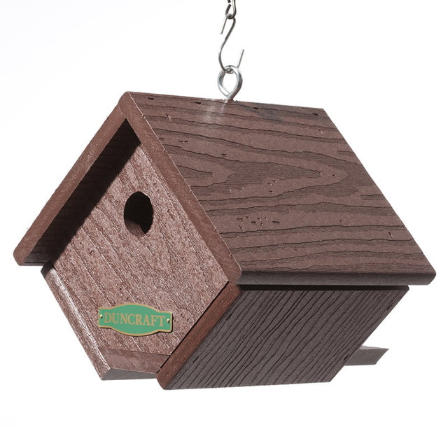 Eco-Strong Wren House hanging from a hook, featuring a 1-1/8 inch entry hole and side ventilation slots for wrens, made from recycled plastic.