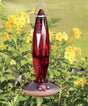 8 oz. Medium Jewel Cut Glass Hummingbird Feeder with faceted design, 3 feeding ports, and decorative flowers, photographed with a hummingbird and flowers in the background.