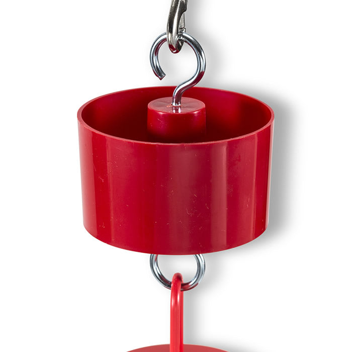 Red Ant Moat Baffle with a hook and metal handle, designed to keep ants away from hummingbird feeders by filling it with water.