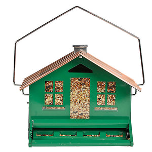 Squirrel Be Gone Home Style bird feeder with green house design and brown roof, featuring a weight-activated perch to deter squirrels and clear windows for seed level viewing.