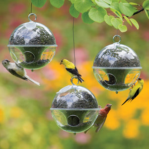 Duncraft Cling-A-Wing, Set of 3, featuring globe-shaped bird feeders with four ports, designed for smaller birds, shown with birds feeding from the feeders.