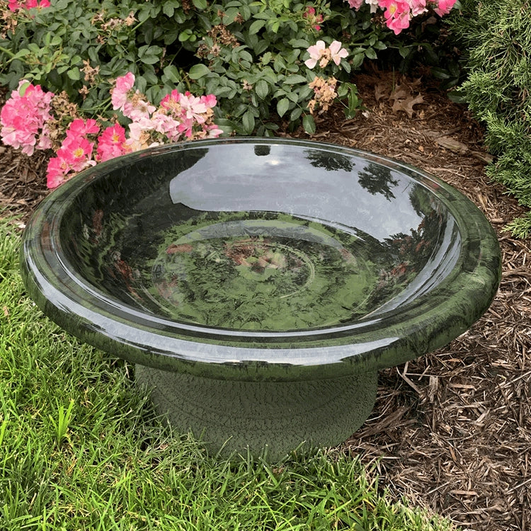Short Hunter Green Fiber Clay Bird Bath in grass, featuring a wide basin ideal for bird watching, lightweight and easy to move, with a natural yard accent.