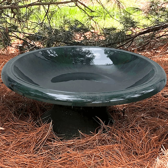 Short Hunter Green Fiber Clay Bird Bath in a natural setting, featuring a wide, shallow basin for easy bird viewing and minimal refilling.