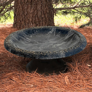 Short Sand Fiber Clay Bird Bath in a wooded setting. Features a low-profile design with a wide basin on a stand, ideal for attracting birds.